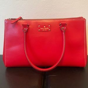 Kate Spade Red Purse.Three compartments, two zippered, middle is a snap